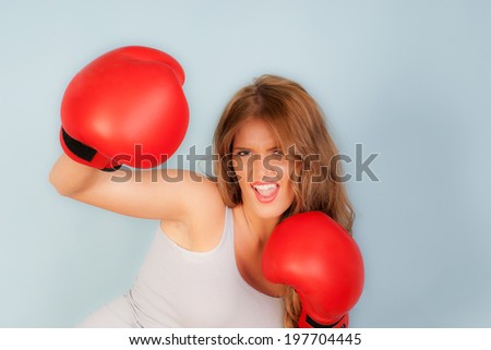 sexy woman in vest wearing red boxing gloves