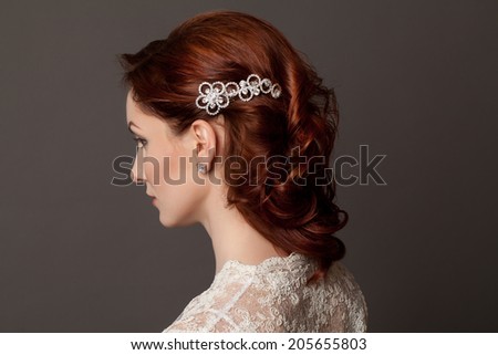 Beautiful sensual woman with elegant hairstyle. Woman with perfect skin, red hair. Wedding fashion