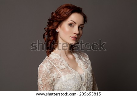 Beautiful sensual woman with elegant hairstyle. Woman with perfect skin, red hair. Wedding fashion