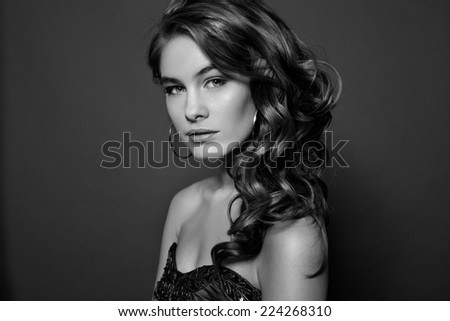 Beauty Model Girl with Long Healthy Wavy Hair and Perfect Makeup. Beautiful Woman with Shiny Hair. Black and white.