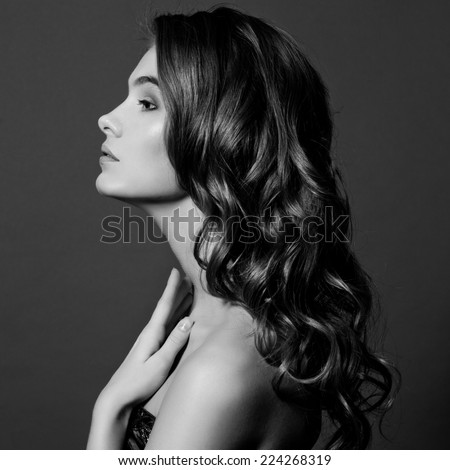 Beauty Model Girl with Long Healthy Wavy Hair and Perfect Makeup. Beautiful Woman with Shiny Hair. Black and white.