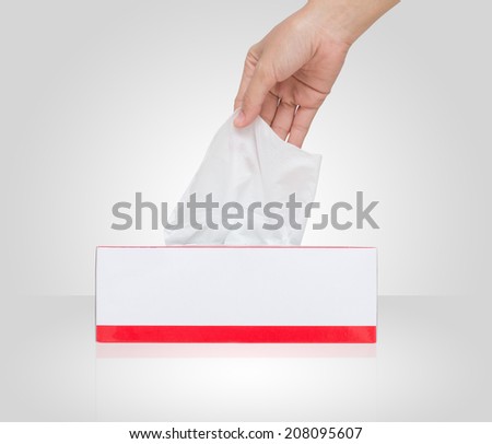 Woman\'s hand pulling white facial tissue from a box, isolated on white with Clipping path