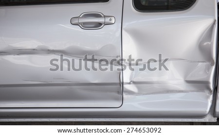A dent in the side of a car