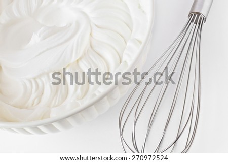 Whipped cream and  a whisk