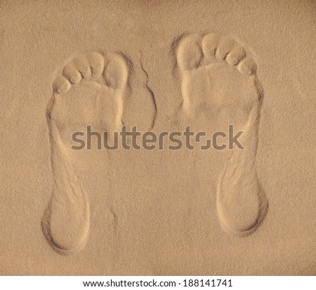Two Footprints in sand at the Beach