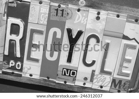 Recycle sign made out of state license plates.  Each letter, spelling the word recycle, is a piece of a state license plate