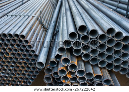 Metal pipes are stored in a warehouse hexagonal cells