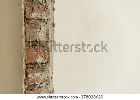 Repair of a wall covered with plaster, on the other wall is still visible brickwork