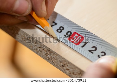 Master ruler measure the board and notes pencil mark