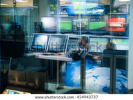 Television blurred background, news studio control panel with monitors through the glass