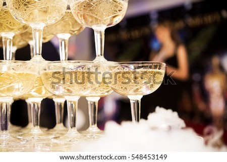 champagne glasses standing in a tower at the party