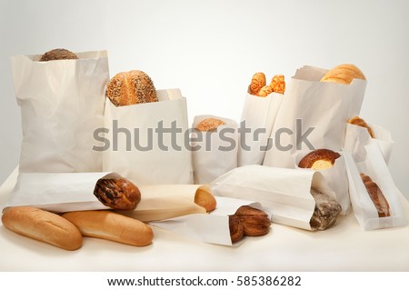 Still life. Bread with different additives with seeds, sesame seeds, cheese, cottage cheese, poppy seeds packed in paper bags.