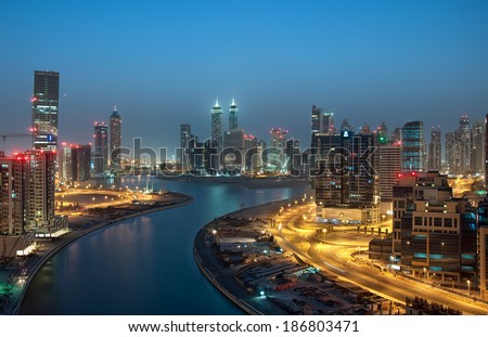 DUBAI, UAE - NOVEMBER 20: Dubai downtown night scene with city lights, luxury new high tech town in middle East, United Arab Emirates architecture on November 20, 2013 in Dubai, UAE.