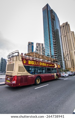 DUBAI, UAE - 3 MARCH, 2015: Dubai BIG Bus Coach seen across Dubai during tourist visit on March 3, 2015. Open-top bus tour reveals all of the famous Dubai landmarks and the city\'s rapid development.