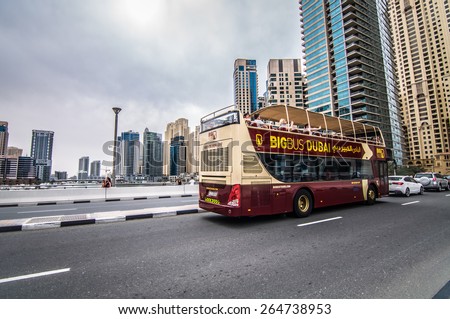DUBAI, UAE - 3 MARCH, 2015: Dubai BIG Bus Coach seen across Dubai during tourist visit on March 3, 2015. Open-top bus tour reveals all of the famous Dubai landmarks and the city\'s rapid development.