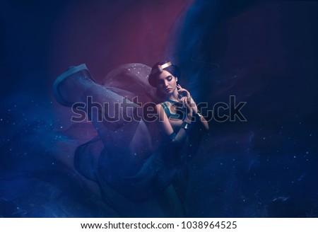 A girl in oriental attire, Queen of the storm. Princess Jasmine. The background is a twist and a strong wind. Studio shooting with mixed light. Artistic Photography