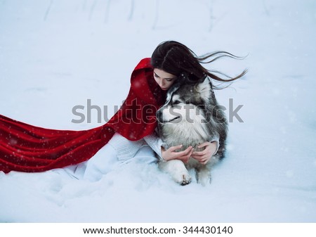 Red Riding Hood lost in the mystical snow-covered forest and met a wolf,fantastic shooting,fashionable toning, creative computer colors
