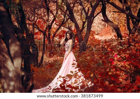 Lady in a luxury lush pink pastel dress   near the tree,fantastic shot,fairytale princess is walking in the autumn forest,fashionable toning,creative computer colors