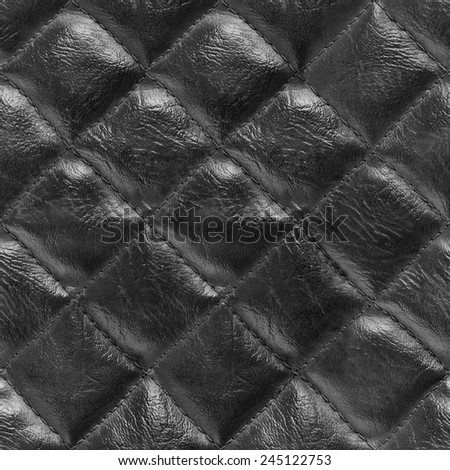 Seamless black leather texture.. close-up of the surface of genuine leather with diamond-shaped stitching
