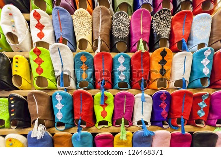 Colorful moroccan babouche shoe slippers in a shelf.