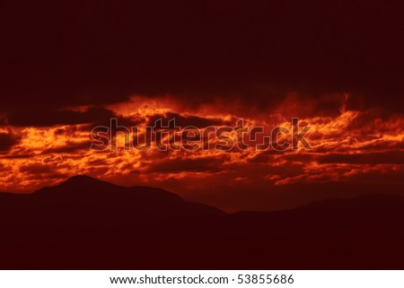 Dark storm clouds with red light. Great impression of distance, danger, emotions. Makes a nice background