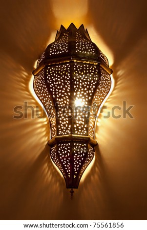 Arabian lamp with beautiful shadows on wall. Concept for Moroccan and Arabian culture and design.