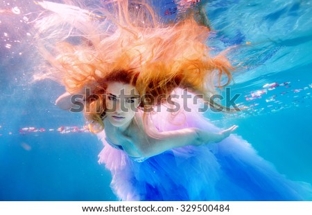 Unbelievable underwater beauty red-head girl in fabulous dress. Real shot.