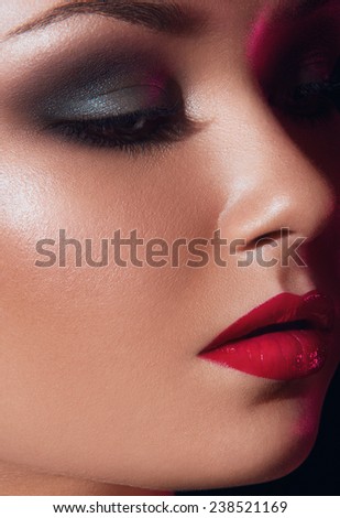 Close up fashion portrait of pretty girl with blue eyes, natural make up eyes closed on black background