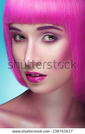 Beauty portrait of a pretty  young women  pink hair woman on blue background.