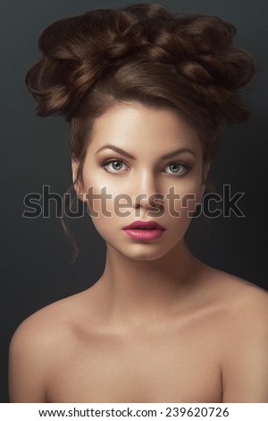 Portrait of beauty nude girl with green eyes, light brown eye-shadows and natural rose lipstick, with curles gathered on the top of the head looking at you and breathing through her open lips