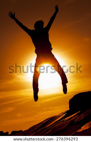 Silhouettes of jumping man