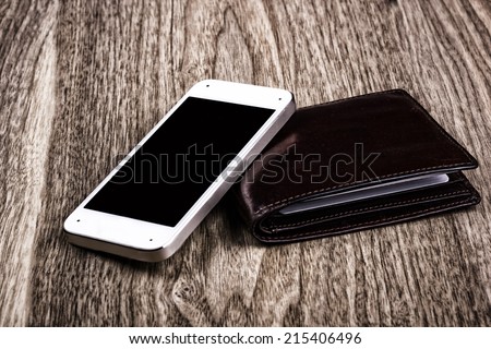 Cellular phone and black leather wallet