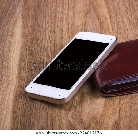 Cellular phone and black leather wallet