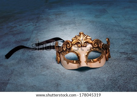 Venetian mask on blue grunge floor