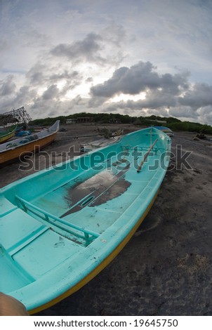 A fishing boat on a tropical beach - fish-eye view