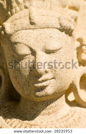 A ancient stone sculpture of a Indian woman