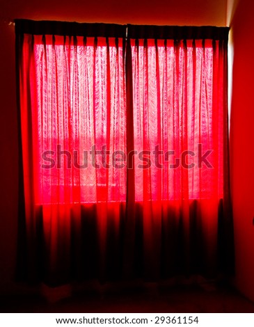 Red sheer curtains on a window