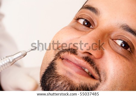 An Indian man getting dental treatment