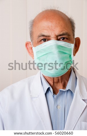 An Indian / Asian doctor or dentist wearing a mask