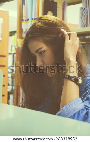 Portrait of asia student looking for a book