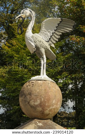 Ornamental Metal Heron with an Eel in its Mouth in a Garden, near Barnstaple, in the County of Devon, England, UK