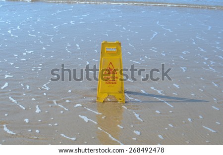 Slippery When Wet Sign on Woolacombe Beach, Devon, England, UK