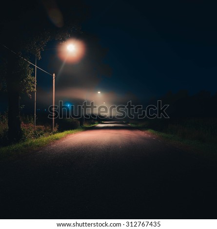 Night street road covered in fog lamps