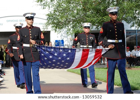 stock-photo-marines-carrying-flag-at-memorial-day-ceremony-13059532.jpg