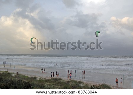 ORMOND BEACH, FL - AUGUST 25:  Spectators watch two unidentified kite-boarders as Hurricane Irene passes off the coast on August 25, 2011, in Ormond Beach, Florida.