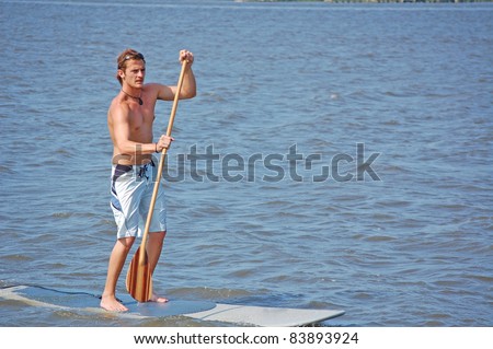 A young man on his paddle-board in the intracoastal river in Florida.