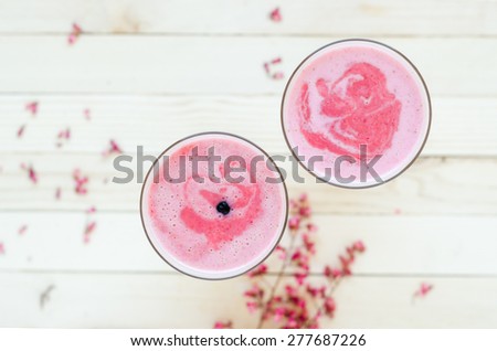 Pink Strawberry smoothie on light brown rustic table