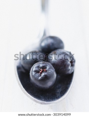 Chokeberries with silver spoon