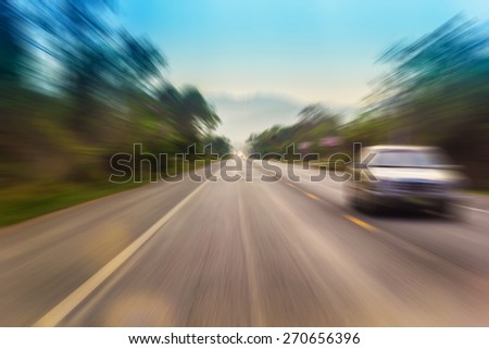 Motion blur of a rural road to infinity from inside a moving car