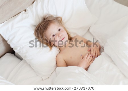 a little girl sick in bed